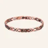 Bracelet de cheville en cuivre rosé, maillons en X croisés, pastilles rondes claires et fermoir à clip Bracelet de cheville en cuivre rosé, maillons en X croisés, pastilles rondes claires et fermoir à clip