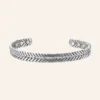 Bracelet jonc ouvert en cuivre argenté, fils torsadés en épi et pastilles rondes aux deux extrémités