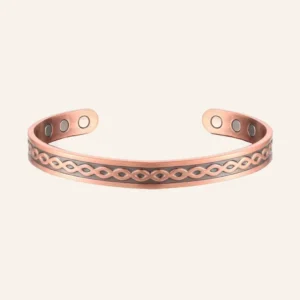 Jonc en cuivre patiné gravé d'entrelacs tressés, six pastilles rondes et aimants aux extrémités